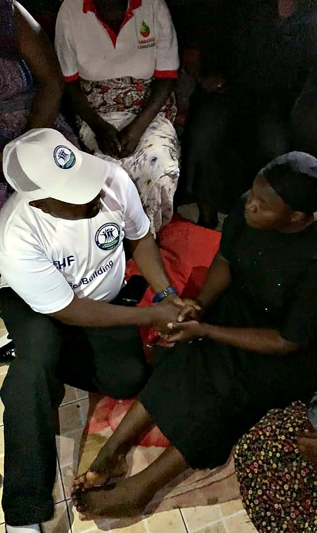 An EHF peacebuilding officer consoling a woman affected by the attack in Anguwan Rukuba