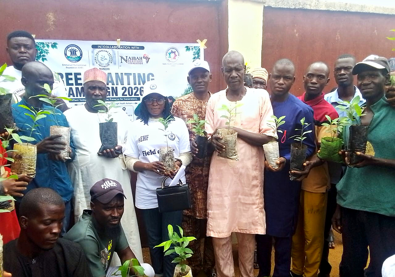 Community members holding Olive seedlings at the Tree Planting Campaign 2026 phase two in Mukuvinye Hlidi B, Hong LGA